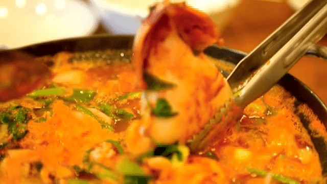 Bubbling pot of Spicy Seafood Stew with squid