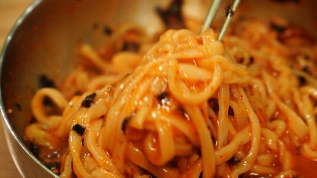 매콤하고 새콤한 비빔국수를 젓가락으로 들어올리는 모습