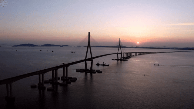 Long bridge over the sea at sunset