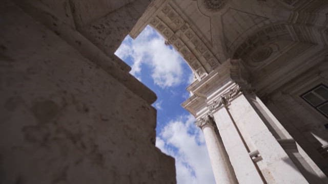 Historic Arch Gate with Blue Sky and Clouds in the Background