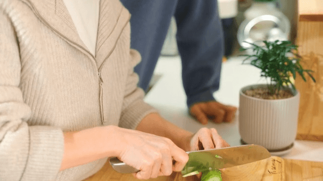 Woman chopping vegetables in a kitchen