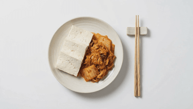 Kimchi and tofu on a white plate