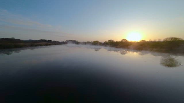 Sunrise over a Misty River Landscape