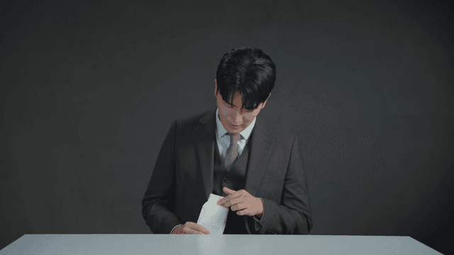 Man secretly counting money inside an envelope