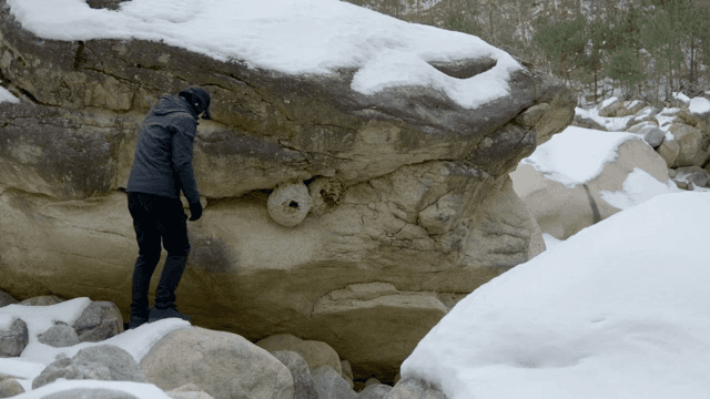 눈 덮인 바위와 탐험하는 사람