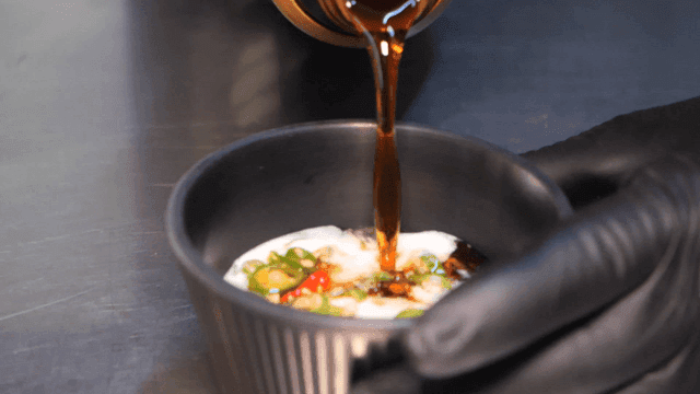 Soy sauce being poured into a bowl
