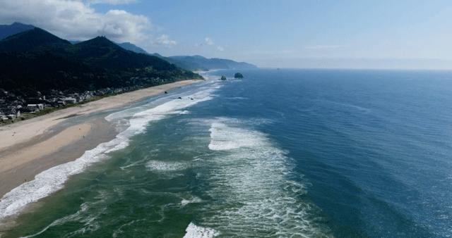 A scenic beach with waves and coastline