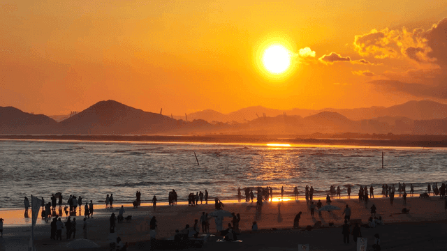 Sunset beach enjoyed by people