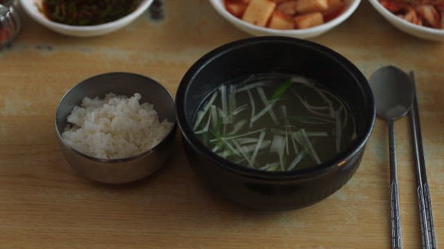 Taking Pictures of a Table Filled with Korean Food with a Phone