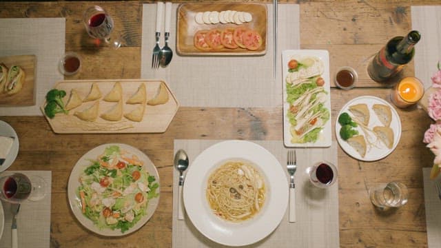 Dinner Table with Various Dishes and Drinks