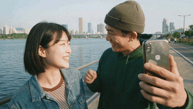 Couple taking selfie by river