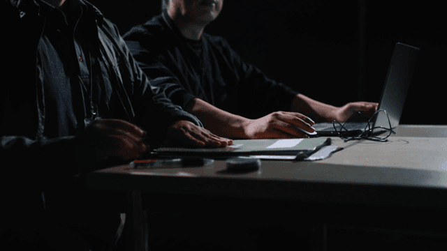 Detectives checking laptops and documents