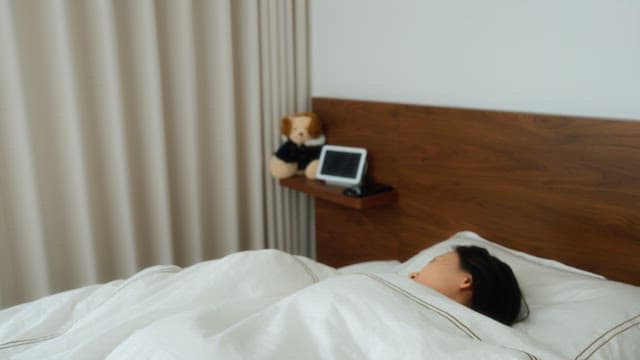 Woman waking up next to digital tablet