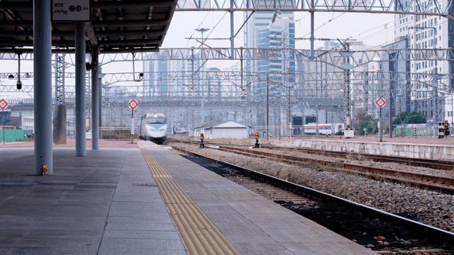 High-speed train approaching city station