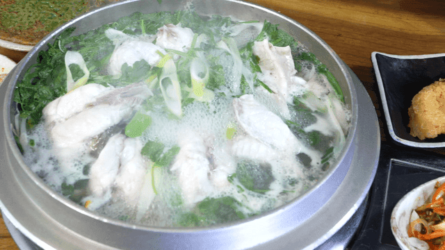 Clear pufferfish soup and fried pufferfish on table