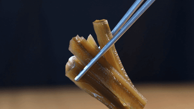 Gungche pickles held with chopsticks