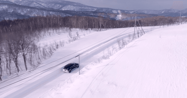 Car driving through a snowy landscape