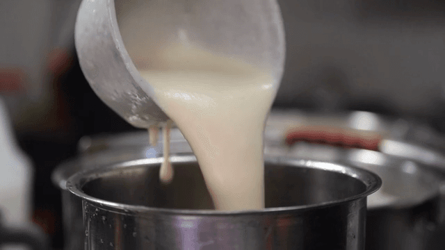 Soybean soup being poured into a pot