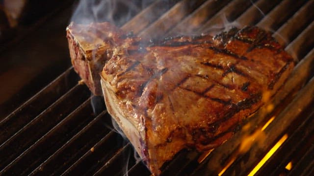 Juicy steak being cut on a cutting board