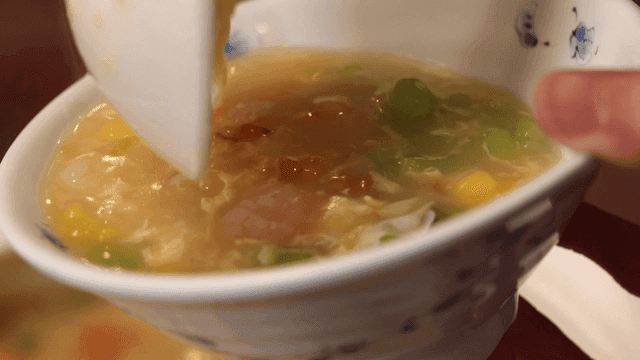 Bowl of colorful handmade noodle and vegetable soup