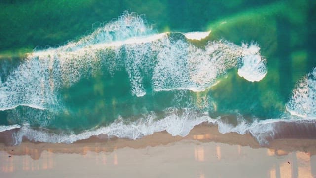 Waves crashing on a sandy beach