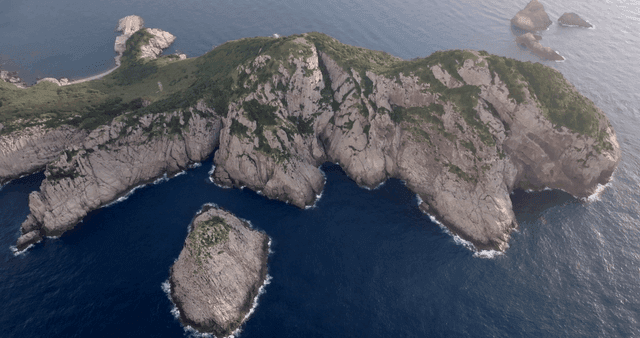 Aerial view of a rocky island in the sea