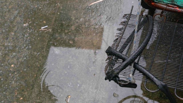 Puddles on wet ground on a cement floor on a rainy day