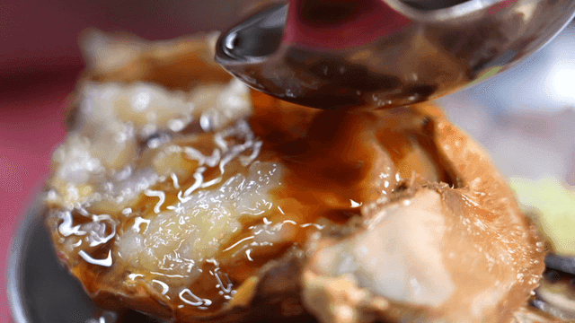 Soy sauce poured over marinated crab