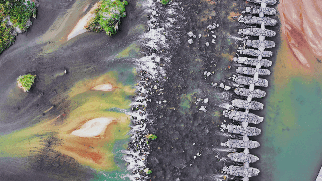 Stone bridge over a mystic-colored river