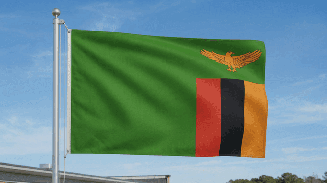 Zambian flag fluttering under clear sky