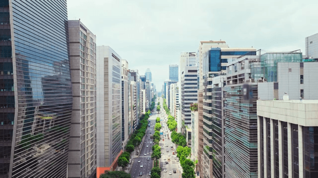 Bustling city street lined with skyscrapers