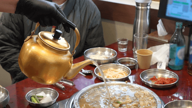 Pork stew with broth poured into pot at table