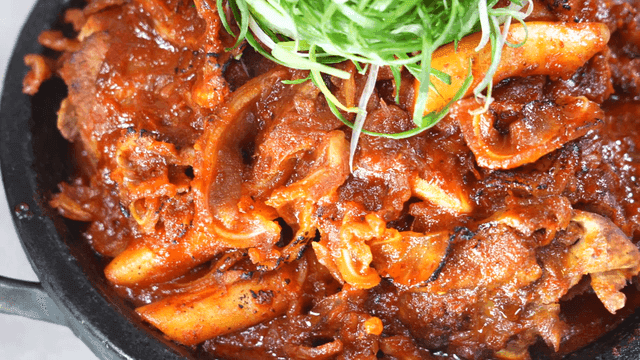 Spicy crunchy braised pork ribs topped with shredded green onions