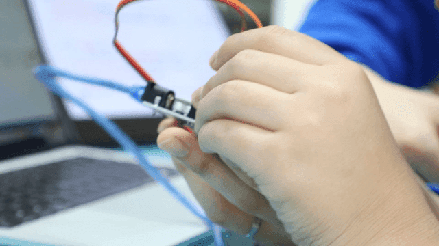 Hands assembling electronic components