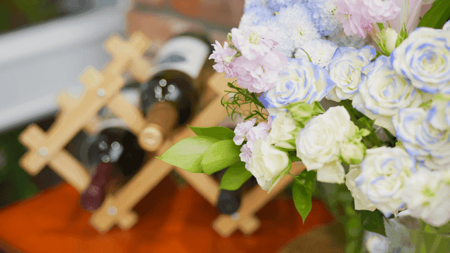 Wine bottles and flowers on a table