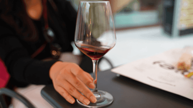 Woman shaking glass of wine
