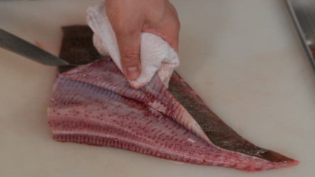 Filleting a tingray on a cutting board