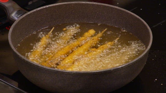 Deep-fried fish fried until golden brown in boiling hot oil