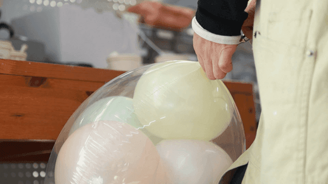 Person who inflates balloons with gas