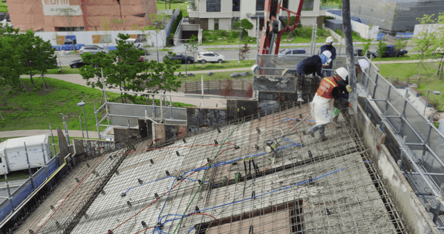 Construction workers pouring concrete