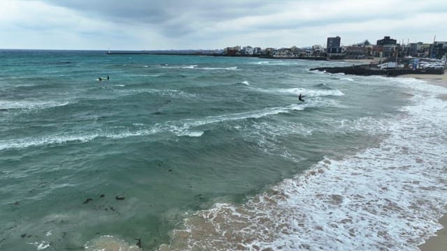 Beach with waves and kite surfers