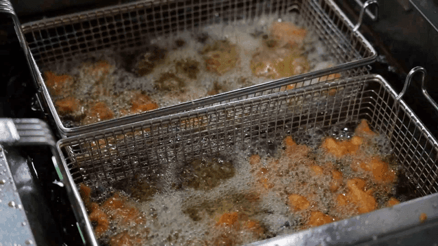 Fried chicken being cooked in hot oil