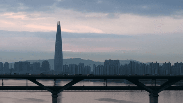 City skyline with a tall tower at dusk