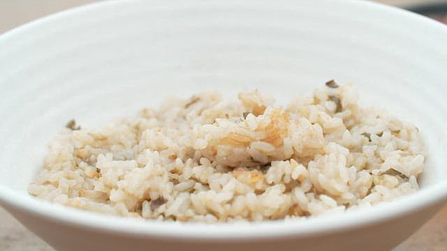 Spoonful of soy sauce seasoning to accompany warm eggplant rice