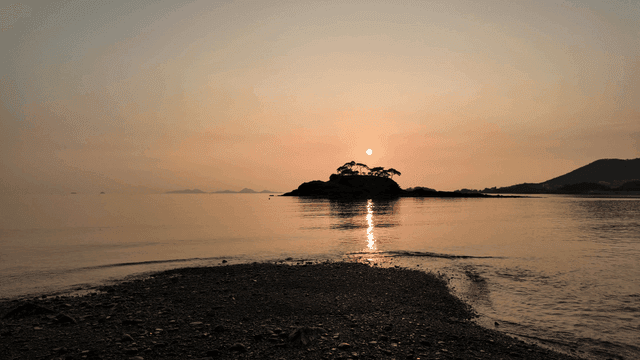 Island and sunset on crashing waves