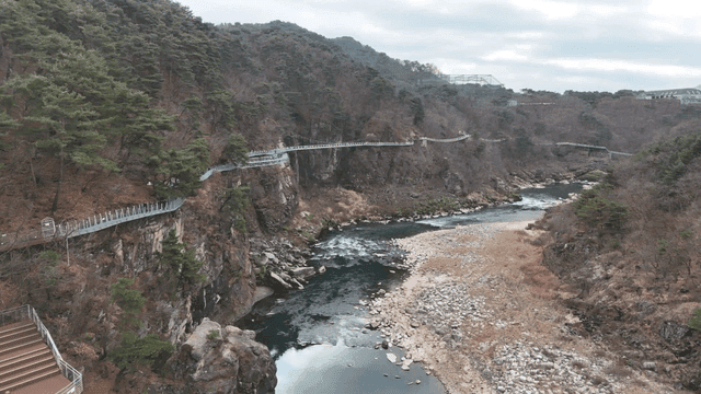 Scenic river with a cliffside walkway