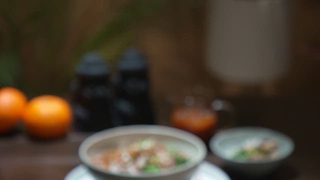 나무 테이블 위에 신선한 소라가 고명으로 올라간 요리