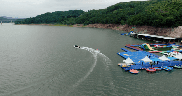 People water skiing on a large lake