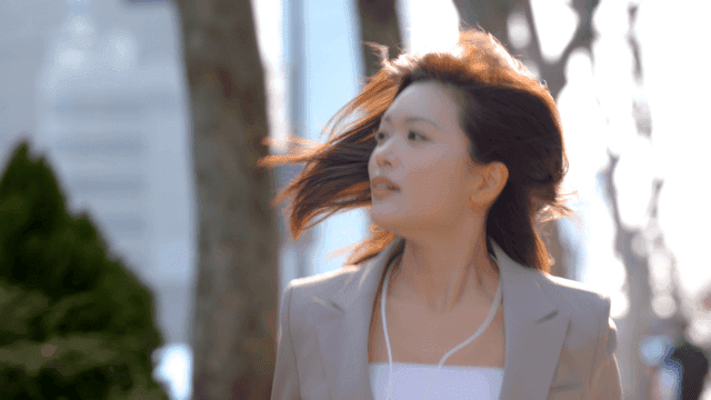 Female office worker in suit running on street