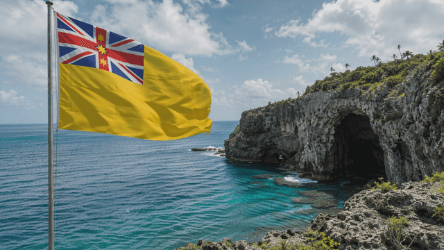 Niue flags waving by sea with cliffs